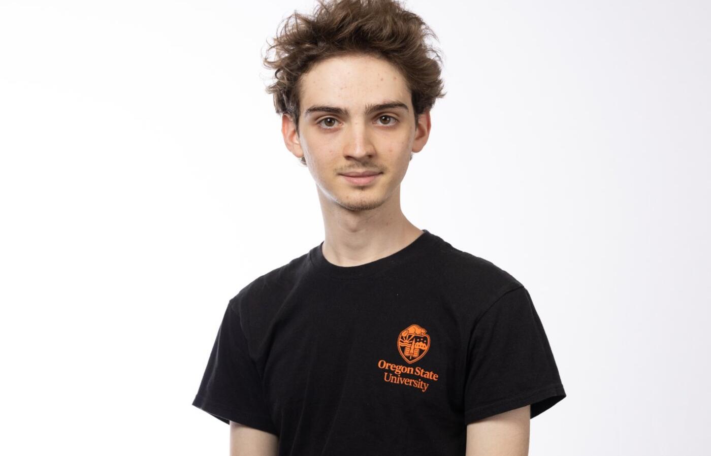 Roain smiling for a portrait in OSU merch