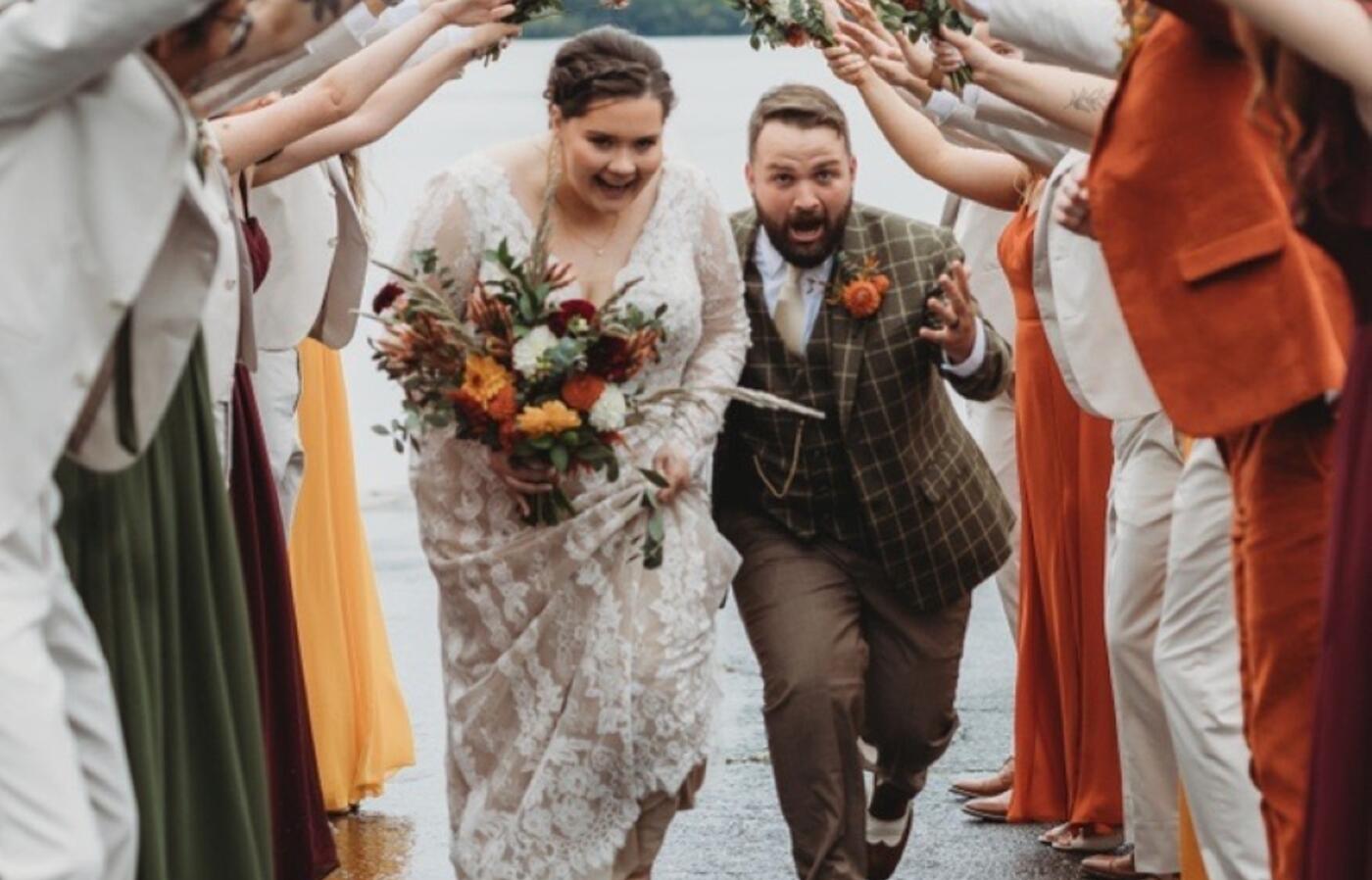 Taylor running with her husband on her wedding day.