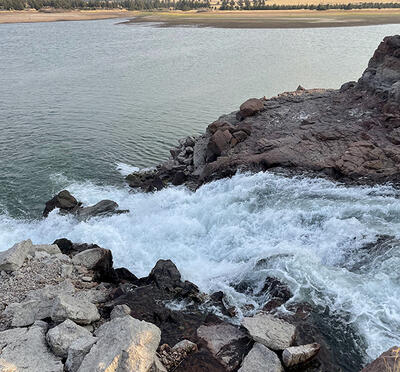 A waterfall flows into a river 