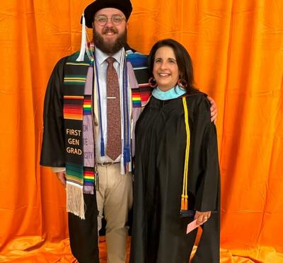 Alex at his graduation with a professor 