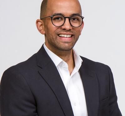 Headshot of James smiling.