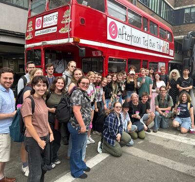 The group gathers for a photo with their tea at the conclusion of their Afternoon Tea Bus Tour. 