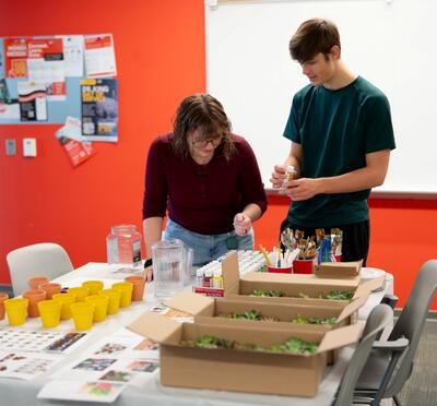 Two HC Students picking out paints for their succulent pots.