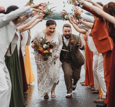 Taylor running with her husband on her wedding day.