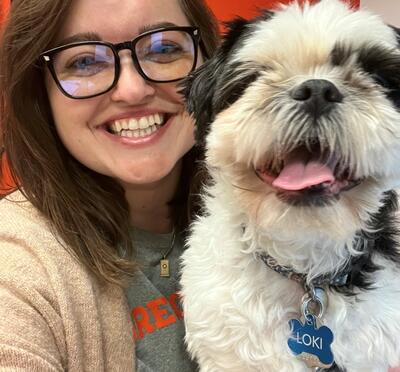 Kara smiling with her dog.