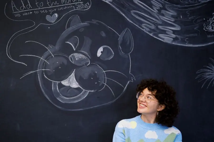 Esme looking at the beaver on her mural.