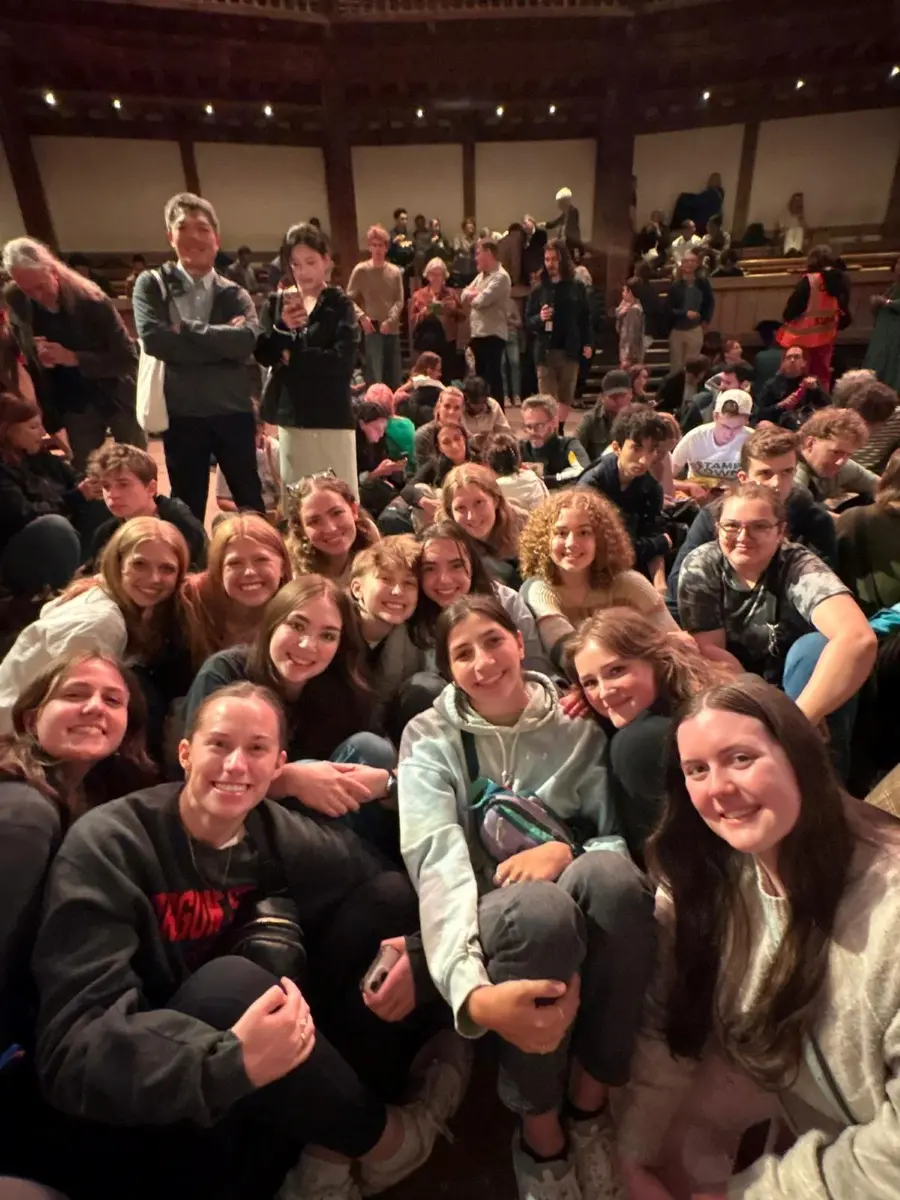 Students smiling after an engaging performance of Twelfth Night at Shakespeare’s Globe Theatre in London.