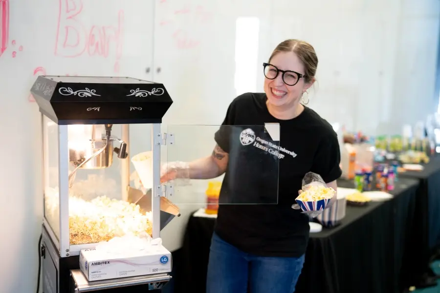 Katelyn Bye serving popcorn at the Popcorn Bar event.