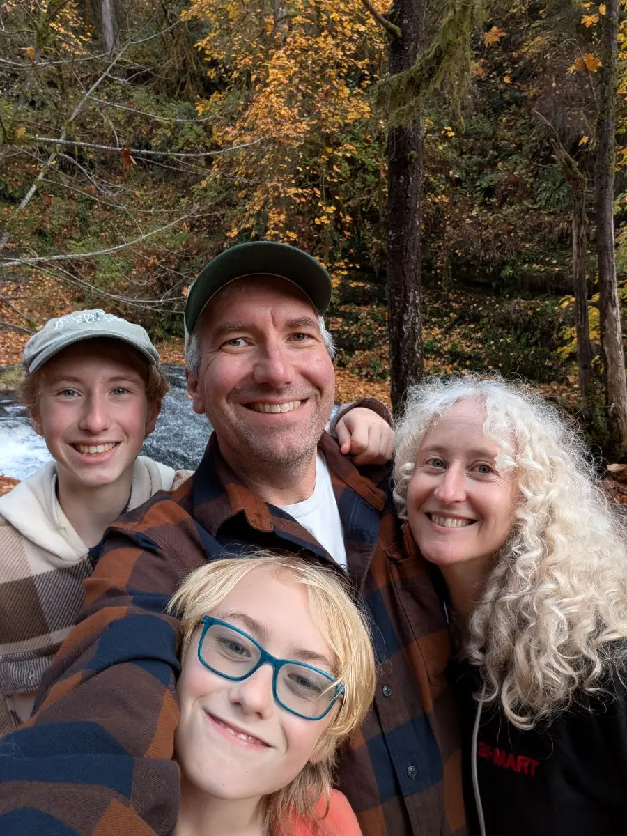 Kevin with his family in the woods.