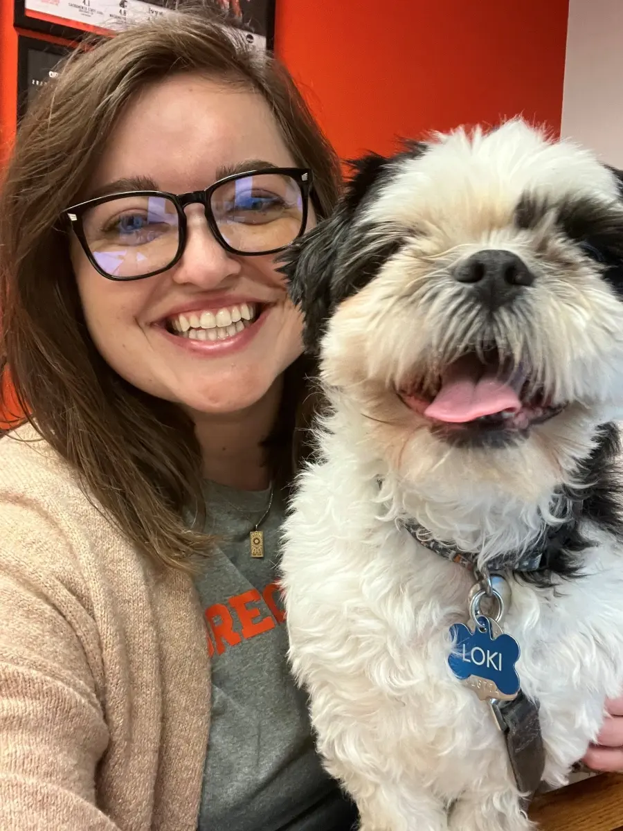 Kara smiling with her dog.