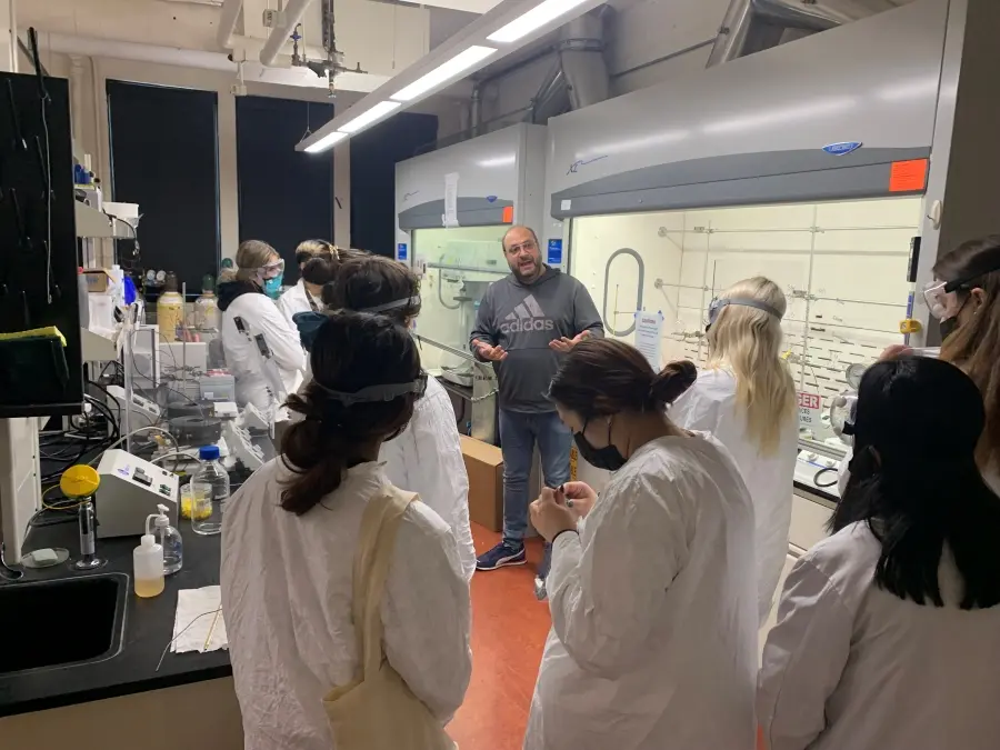 Dr. Kyriakos Stylianou speaks with honors general chemistry students in his laboratory in Gilbert Hall.
