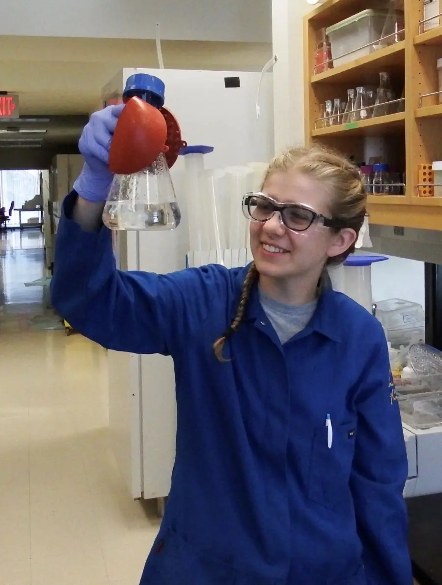 Jessica Flesher holding up an Erlenmeyer flask.