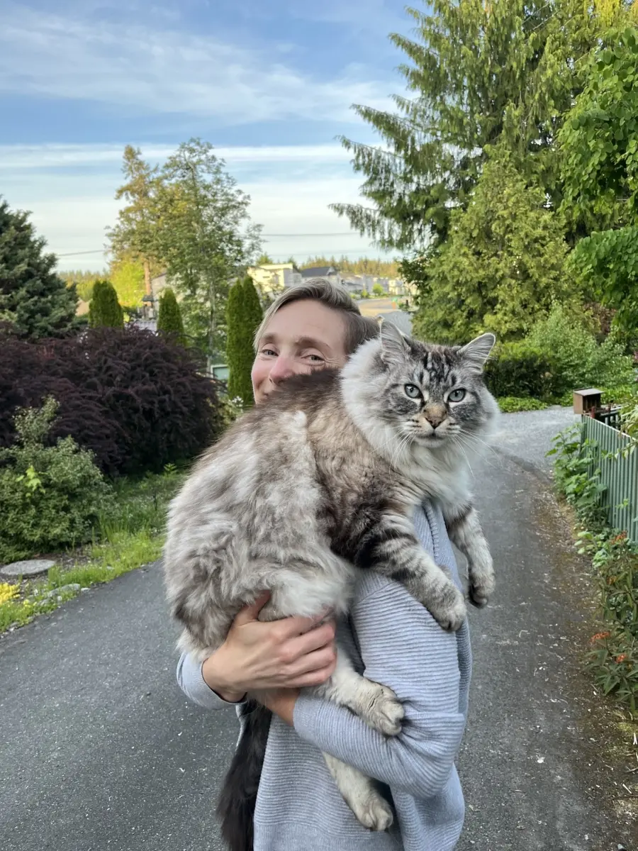 Diana Marvel smiling while holding a cat.