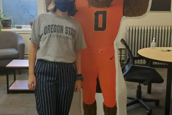 Julia Notz nstanding next to a Benny Beaver cardboard cutout 