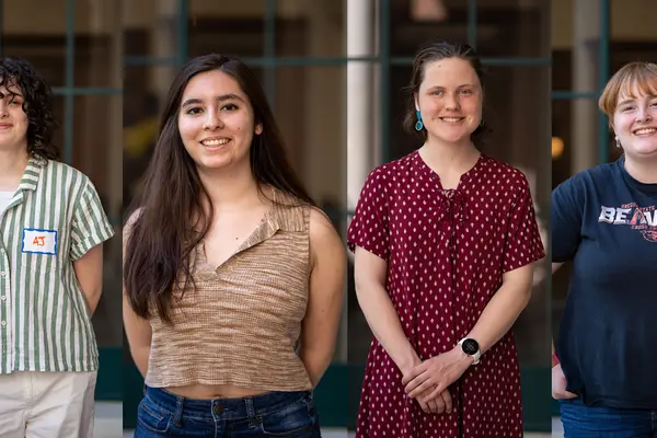 Four Honors College students smiling in front of PRAx
