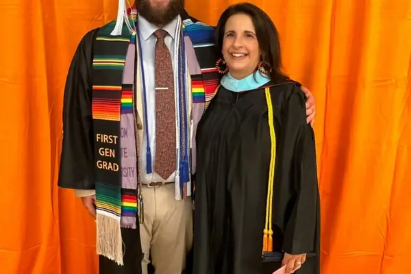 Alex at his graduation with a professor 