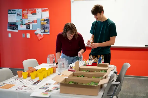 Two HC Students picking out paints for their succulent pots.