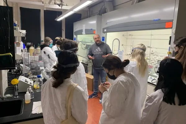 Dr. Kyriakos Stylianou speaks with honors general chemistry students in his laboratory in Gilbert Hall.