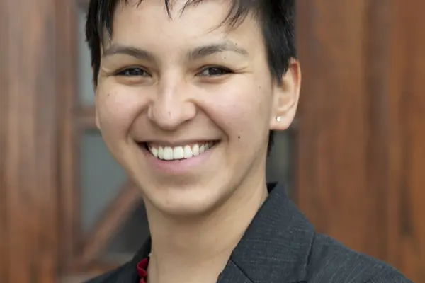 Tari Tan smiling in a dark gray suit.