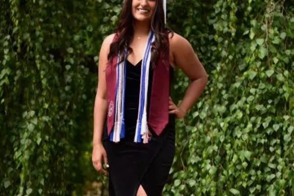 Shrida Sharma with her graduation cap, cords, and stole