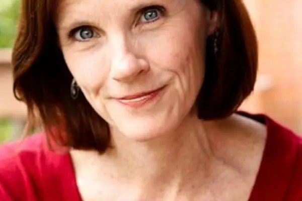 Susan Jackson Rodgers smiling in a red top 