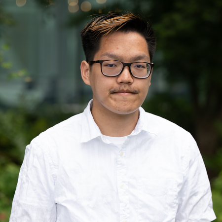 Josiah smiles for a headshot. 