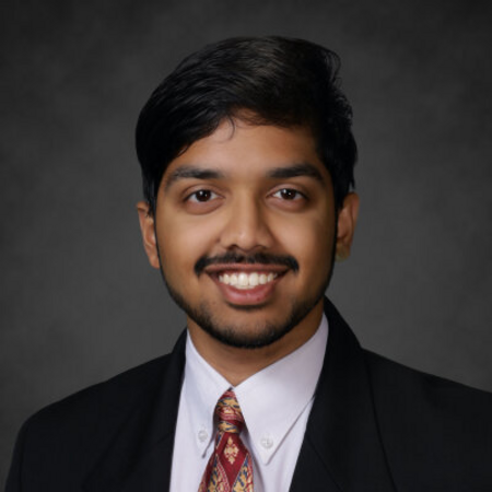 Tejas smiles for a headshot.